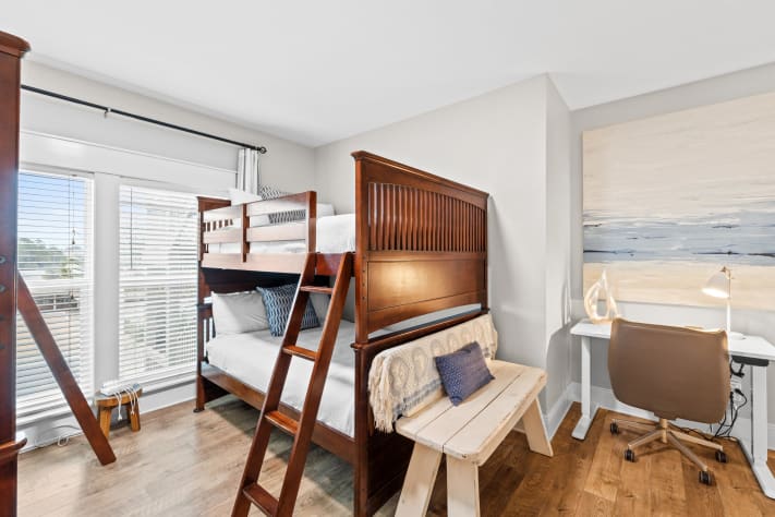 Second bunk room with two full-over-full bunks plus a dedicated desk for remote work or school. Perfect mix of fun and function.