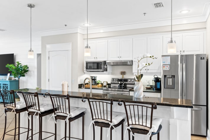 Cook like a pro in the fully equipped gourmet kitchen with stainless appliances, granite counters, and breakfast bar seating. Perfect for big meals, quick snacks, or enjoying coffee with Gulf views.