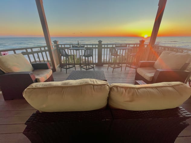 Cozy lounge seating with unobstructed sunset views. Enjoy cocktails, conversation, or simply relax as the sky turns brilliant shades of orange and pink. The ultimate beachfront retreat for couples or groups.