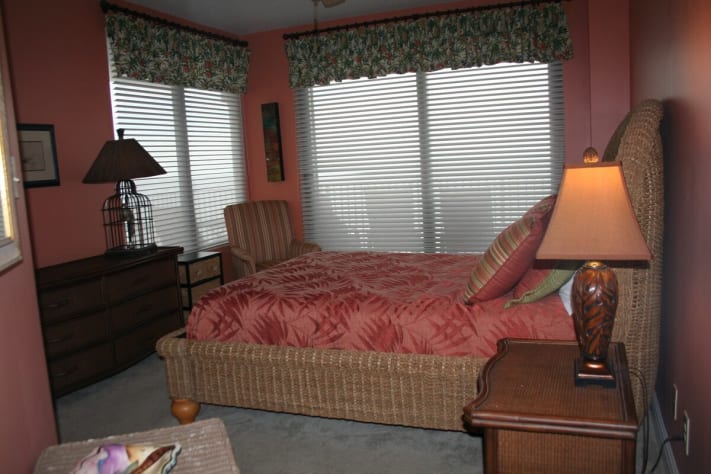 bedroom 2 with queen bed and doors to access balcony