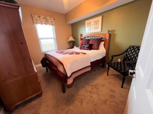 Queen-sized bedroom with soft carpet and ample storage space to store your belongings.