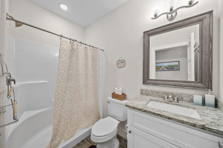 Bath room with essentials Shampoo, Conditioner, Body wash, Hair dryer, towels