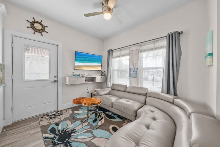 Living room couch with Smart TV and live wood side table, books