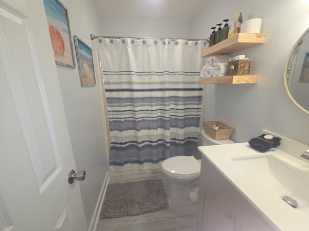 New vanity and mirrors comfort height toilet. Bath and shower combo
