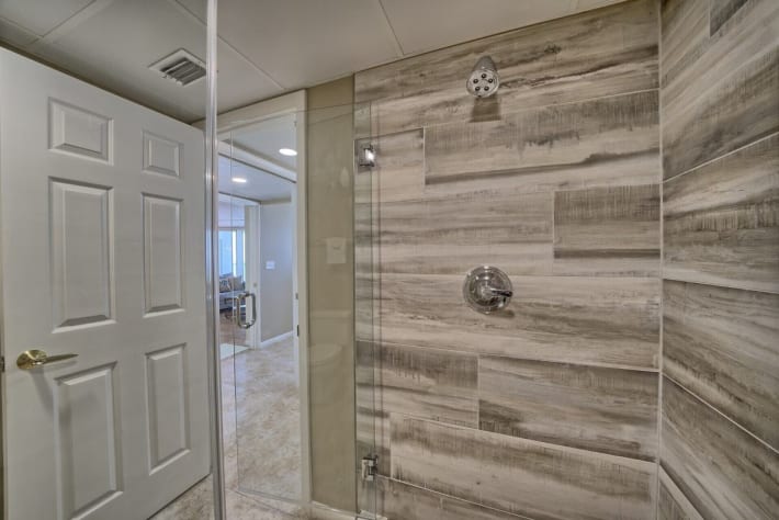 Check out the large walk in shower with new tile and glass door