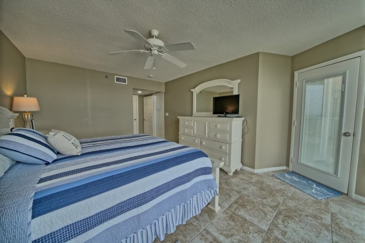 Door opens to oversized balcony with bistro table and high back chairs. Modern!