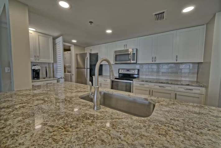 New cabinets, backsplash, cabinets, tile flooring, dishes, cooking utensils