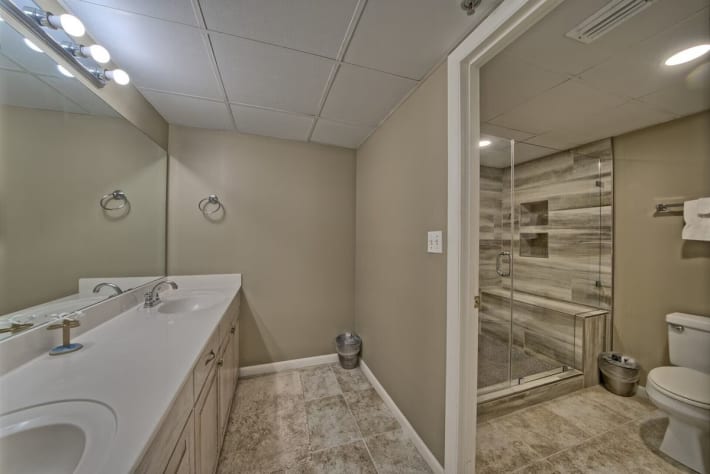 Modern spa like bathroom with new tile, double vanity and one of two master bath