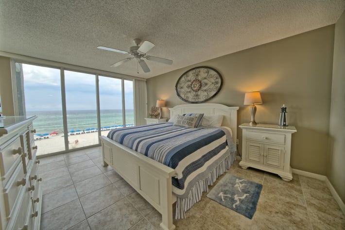 Large dresser, king bed, and 2 size stands, large mounted TV. Door opens to deck