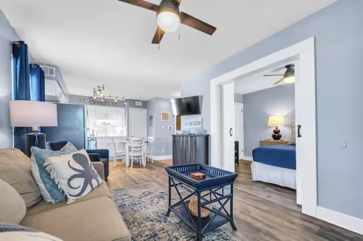Open-concept living area connecting to kitchen and bedroom