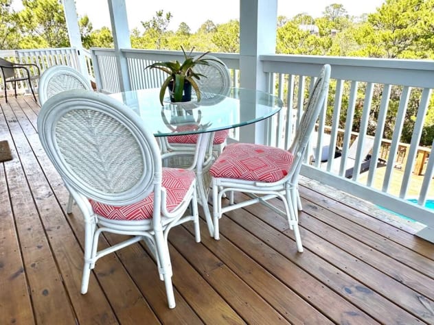 The back balcony is perfect for meals, doing work, overlooking the pool and all the wetlands surrounding most of the house. The bambook table and chairs are antique and quite comfortable.