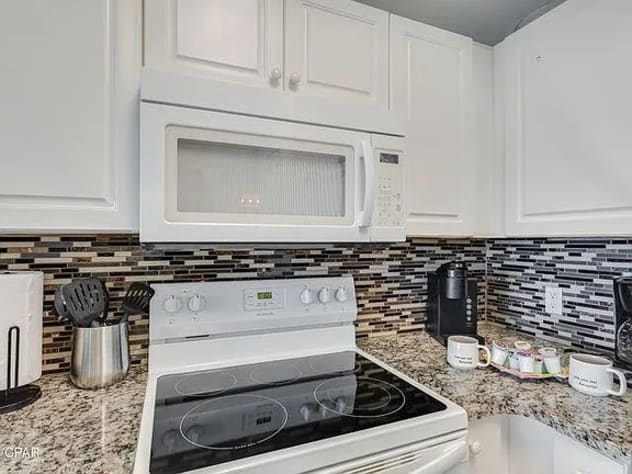 Fully equipped modern kitchen with granite counters stylish cooking appliances