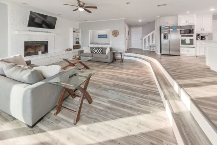 Spacious open-concept living area with modern coastal d&eacute;cor.