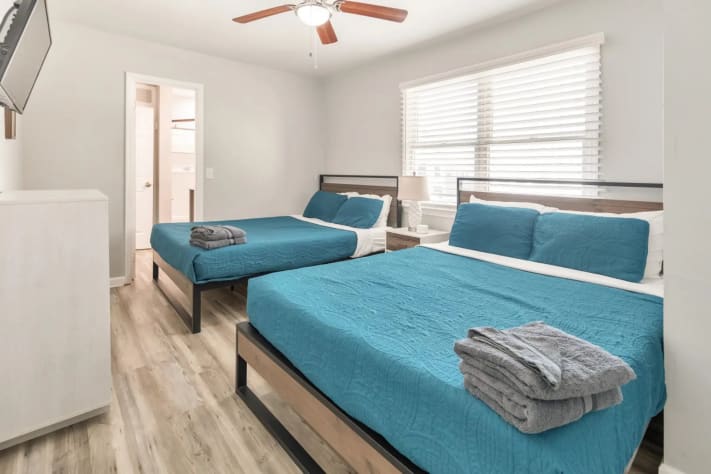Relaxing bedroom with two beds and entertainment setup