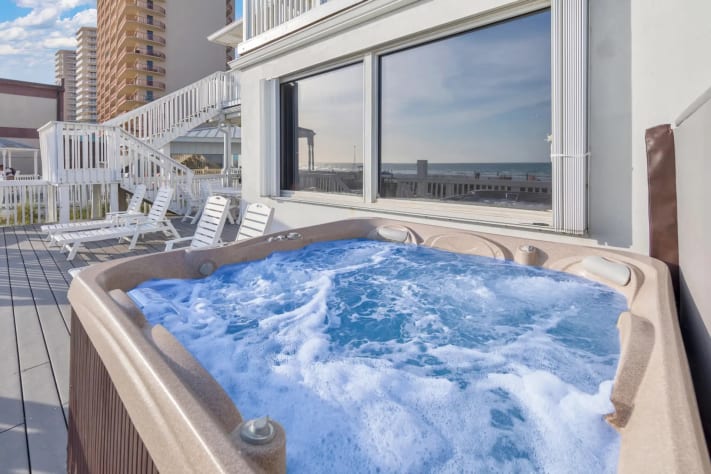 Unwind in the hot tub while soaking up panoramic views of the ocean and city.