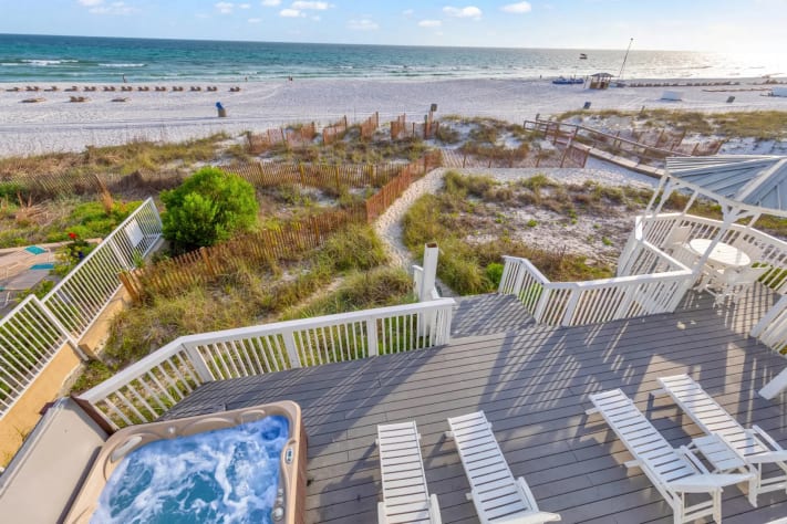 Step straight onto the sand from this beautiful beachfront home with large outdoor living areas.