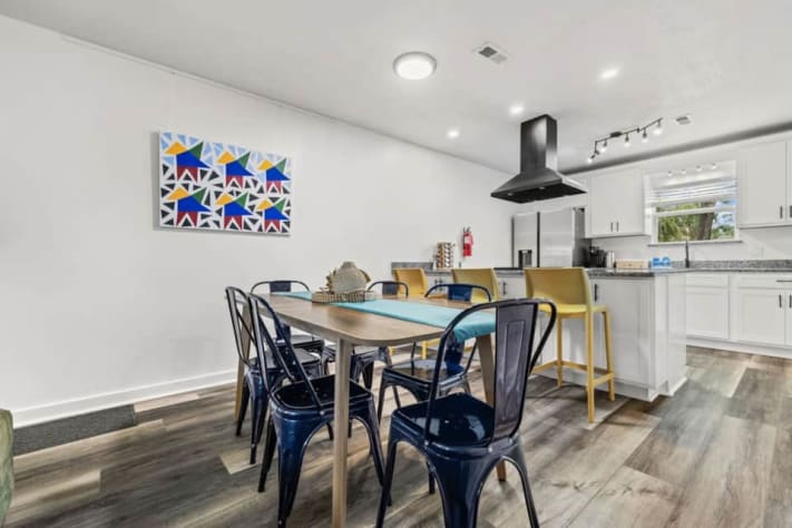 Unit A's dining table seats six, with three more seats at the island. A high chair and Pack 'n Play are available for little ones. Cook in the fully stocked kitchen while staying connected to the smart-TV lounge, or dine on the covered patio