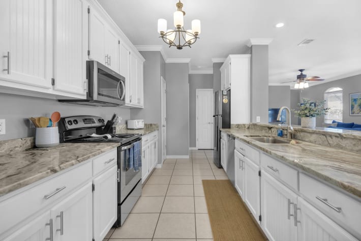 Well equipped kitchen with granite countertops