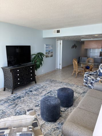Newly painted, new sofa sleeper, rug, ottomans and chairs