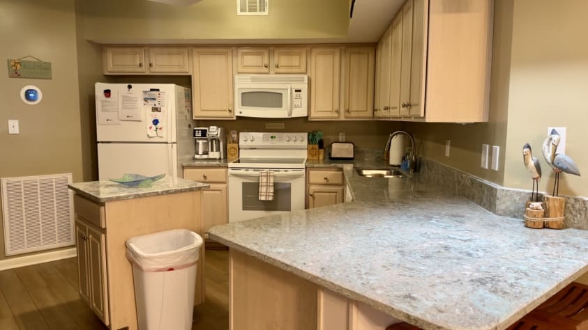 Fully Stocked kitchen with coffee pot, many options for pans, and dishwasher.