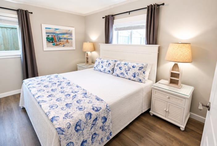A King Suite with an en-suite full bathroom features a private primary bedroom with a king-size bed and an attached, dedicated full bathroom.  