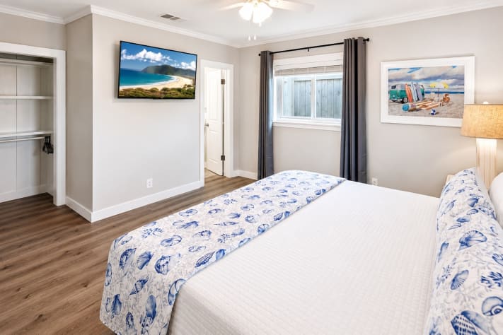 A King Suite with an en-suite full bathroom features a private primary bedroom with a king-size bed and an attached, dedicated full bathroom.  