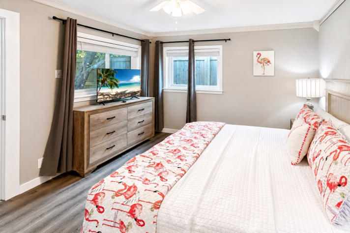 A King Suite with an en-suite full bathroom features a private primary bedroom with a king-size bed and an attached, dedicated full bathroom.  