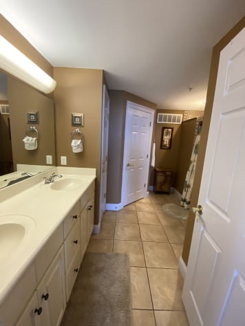 Master ensuite with double sinks, large walk-in closet &amp; newly tiled shower.