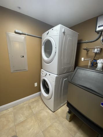 Laundry room with large commercial ice machine inside of your unit!