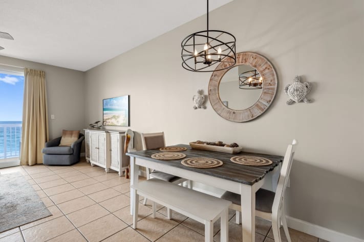 Coastal dining area with ocean views, beach decor, and modern lighting