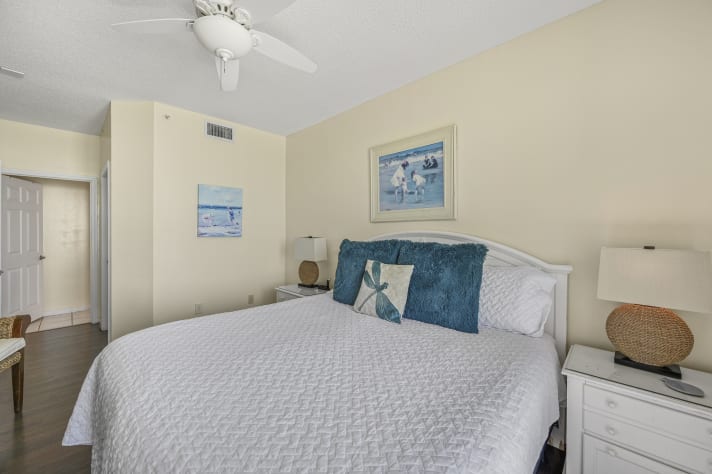 The master bedroom is bright and beachy with a King bed with new mattress, Smart TV, large closet, and bathroom with dual vanity with shower/tub combo
