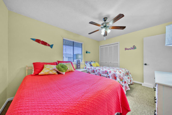 large walk in closet with plenty of luggage space and lots of coat hangers