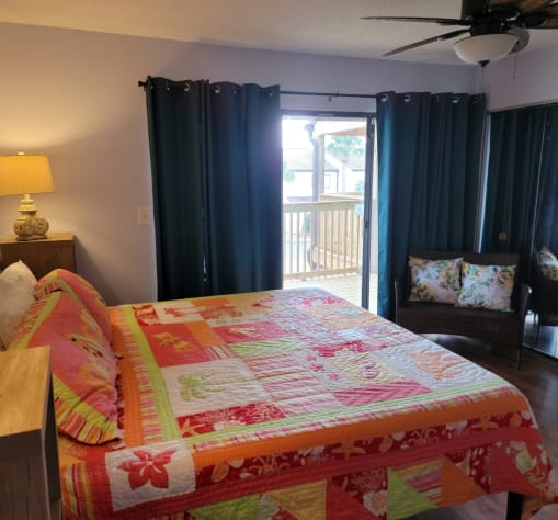Master bedroom with private balcony.  King size, comfy bed.  