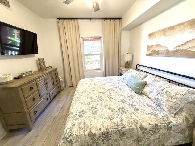 KING Front Bedroom with mirrored closet and private bath access. 