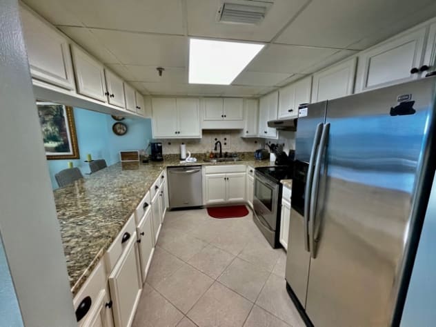 Kitchen shows appliances, cabinets, counter tops, with Breakfast Bar