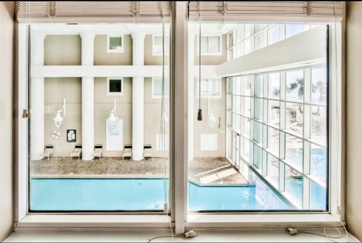 Living room and Dining room windows overlook the Indoor Pool space - perfect for watching the kiddos below!
