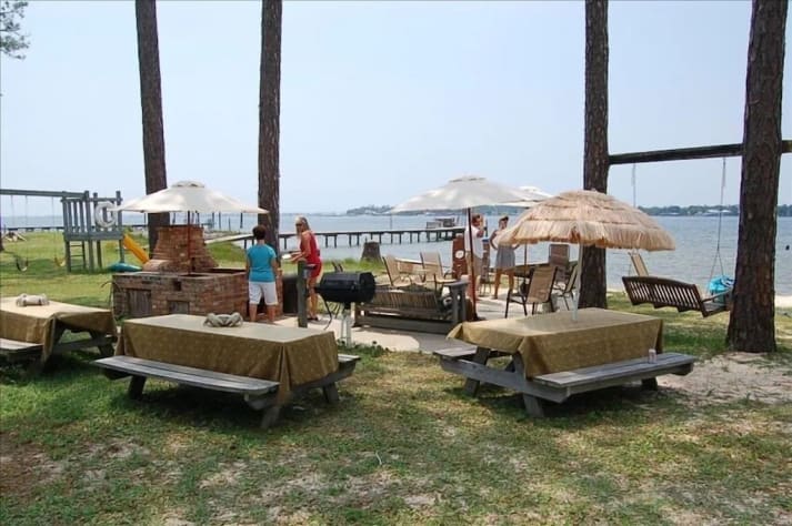 Plenty of picnic tables for outdoor dining.  Brick firepit provides such fun!