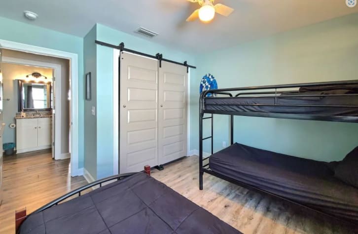 Club Shark Tank has 3 twin beds and a smart TV inside the closet