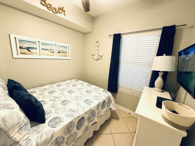 Queen 3rd Bedroom with wall-mounted smart TV