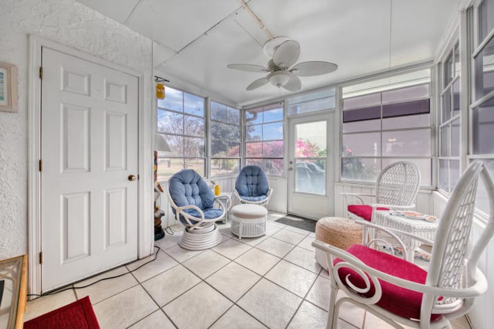 multiple chairs, tables, lighting and ceiling fan to enjoy day or night