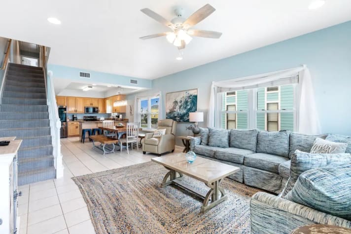 Living room with open access to the dining area and kitchen
