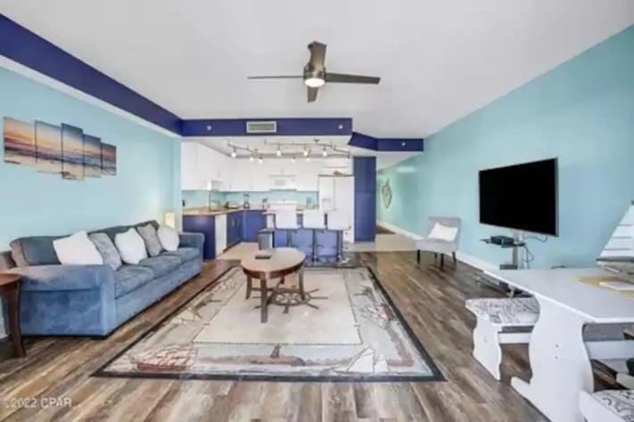 Living room with sleeper sofa and a fully-equipped kitchen 
