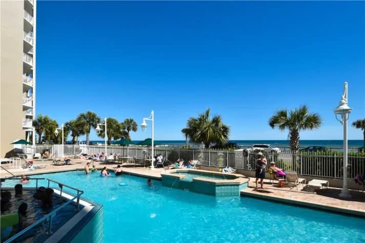 Outdoor pool with views of the Gulf and two hottubs