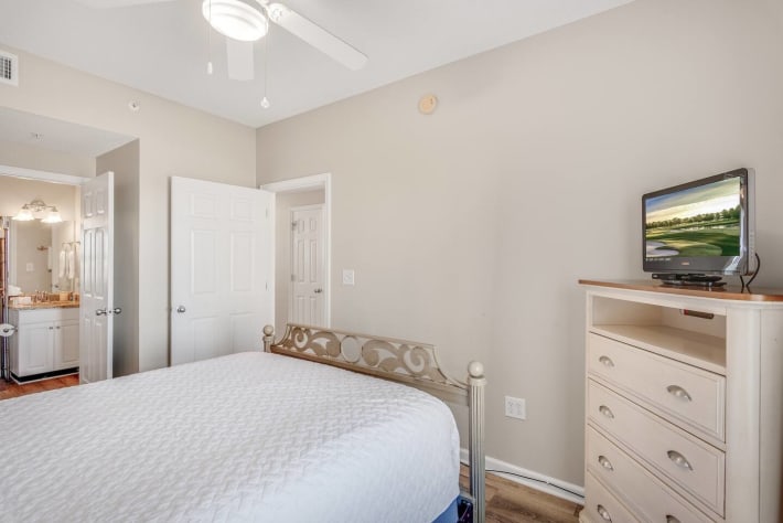 Secondary bedroom with Queen bed, flat screen TV, and private bath