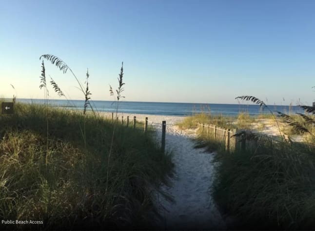 Stroll to the beautiful emerald water down this soft, powdery path.