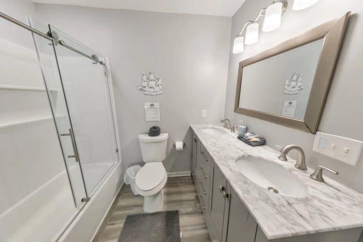 Full bathroom with a tub/shower combo, double vanity, and modern design.