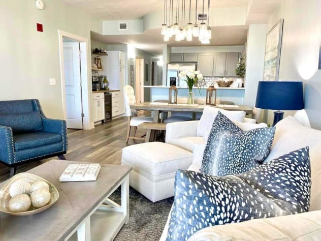 Gorgeous living room with 83" tv and sleeper sofa.