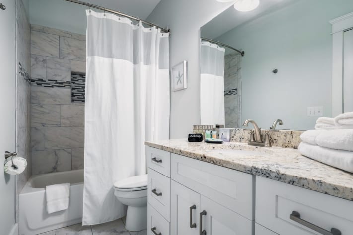 Bathroom attached to upper level Bedroom with shower and tub!