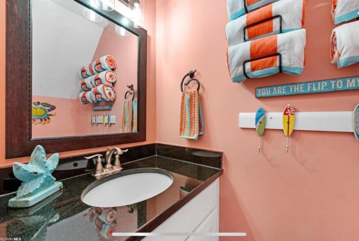 guest bathroom under stairs, with beach towels