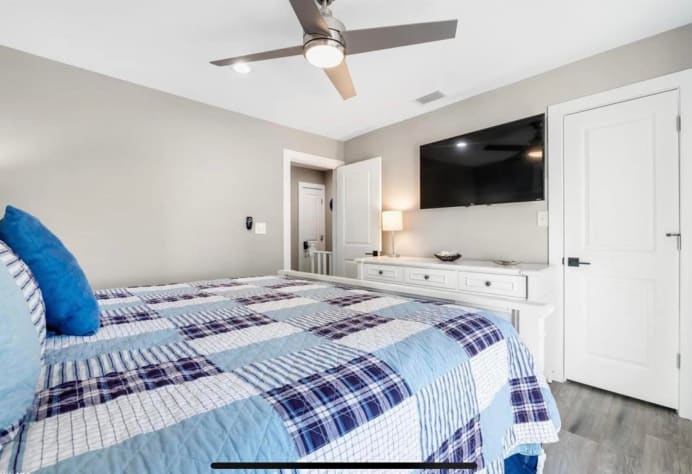 Master Bedroom with chest of drawers and 49" TV
